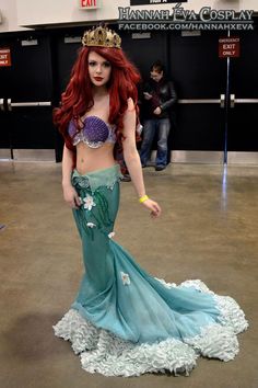 a woman with red hair wearing a mermaid costume