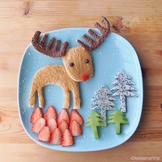 a plate that has some food on it with reindeer and pine trees in the background