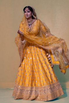 Indulge in the luxurious beauty of this enchanting lehenga, adorned with exquisite mirrors, pearls, stones, and intricate embroidery. This opulent piece will effortlessly enhance your innate elegance and splendor. Color - Yellow Fabric & Work Style - - Silk blouse: mirror, pearl, stone, embroidery work. - Soft net lehenga: mirror, pearl, stone, embroidery work. - Soft net dupatta: embroidery work. Details - - Assured quality - Wash care instruction: Dry clean only. - Slight variation in color is Elegant Raw Silk Lehenga With Gota Work, Elegant Lehenga With Gota Work In Raw Silk, Elegant Designer Choli With Gota Work, Elegant Raw Silk Lehenga With Resham Embroidery, Elegant Designer Chanderi Choli, Elegant Gota Work Choli For Festive Season, Traditional Kundan Gown For Reception, Floor-length Tissue Silk Traditional Wear With Dabka Work, Elegant Choli With Gota Work For Diwali