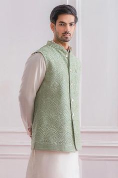 Mint green Lucknowi Nehru jacket with delicate thread and sequins embroidery.
Component: 1
Pattern: Embroidered
Type Of Work: Sequins
Neckline: Mandarin
Sleeve Type: Sleeveless
Fabric: Pure Georgette; Lining: Twill Satin
Color: Green
Other Details: 
Front button down jacket
Note: The kurta and churidar worn by the model is not for sale
Occasion: Mehendi and Haldi - Aza Fashions Green Nehru Jacket With Resham Embroidery For Transitional Season, Festive Embroidered Pista Green Nehru Jacket, Green Nehru Jacket With Resham Embroidery For Eid, Eid Green Sherwani With Floral Embroidery, Festive Green Nehru Jacket With Intricate Embroidery, Pista Green Nehru Jacket With Chikankari Embroidery For Eid, Pista Green Nehru Jacket With Chikankari Embroidery, Festive Pista Green Embroidered Nehru Jacket, Green Floral Embroidered Nehru Jacket For Eid