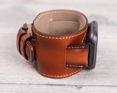 "Full Grain leather burnished tan cuff band for Fitbit Versa 1-2-3-Lite-Sense This watch strap is medium size and fits 6\"-7.6\" (150-190mm) wrists. Four different color options for adapters (Silver, Black, Rose Gold, Gold). Adapter color and buckle color will be same. Shipping: Shipping within US takes usually 3 business days via USPS/FedEx, to Europe 1 business day via TNT Express.We normally send the orders in 1 or 2 business days. Customization: We can write messages, names, dates and coordi Brown Cuff Watch With Leather Strap, Brown Cuff Leather Strap For Watch, Brown Leather Strap Cuff Watch, Leather Watch Bands For Outdoor, Adjustable Leather Watch Bands For Outdoor, Brown Leather Watch Accessories For Outdoor, Brown Leather Outdoor Watch Accessories, Brown Leather Cuff Watch Band, Brown Leather Cuff Watch Accessories