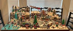 a large lego christmas village is displayed on a table