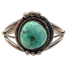 Turquoise stone diameter: 0.85″ Bracelet Inside diameter: 2.30″ Bin Code: A4 / P20 Step into the world of vintage elegance with this exquisite turquoise silver antique cuff bracelet. Crafted with meticulous attention to detail and imbued with a sense of timeless beauty, this bracelet is a true testament to the allure of vintage jewelry. The focal point of this bracelet is the mesmerizing turquoise stone, boasting a diameter of 0.85″. Known for its captivating blue-green hues, the turquoise stone Turquoise Bracelet Cuff Yourgreatfinds ♥ Vintage Jewelry, American Art Deco, Vintage Cuff Bracelet, Green Hues, Vintage Elegance, Silver Cuff Bracelet, Silver Cuff, Classic Elegance, Turquoise Stone