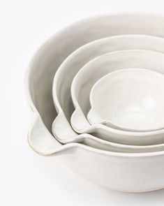 a stack of white bowls sitting on top of each other