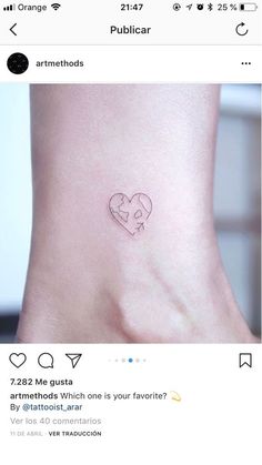 a small heart tattoo on the side of a woman's leg, with two hearts in it