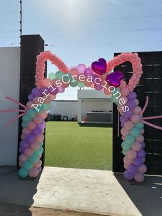 an arch decorated with balloons in the shape of a cat