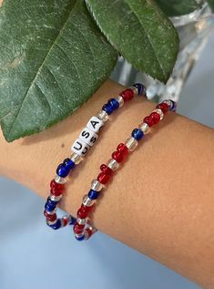 Red, white, and blue beads with USA name Red Round Beads Bracelets For 4th Of July, Blue Stretch Bracelet For 4th Of July Gift, Red Beaded Bracelets For 4th Of July, Patriotic Colorful Beads Bracelet For Gift, Beaded Bracelet For 4th Of July, Patriotic Red Beaded Bracelets, Patriotic Red Beaded Bracelets With Round Beads, Patriotic Red Beaded Bracelet With Round Beads, Patriotic Blue Beaded Stretch Bracelet