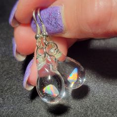 "My friend Marcy named this style of earrings. She said they look like Mermaid's tears. These teardrop dangle earrings are crafted by melting borosilicate glass tubing (pyrex) and blowing a bubble at the end of the tube in the flame, encasing a white Gilson opal nugget inside. The opal flashes with blue, green, yellow, and red hues within the glass. Only first-quality borosilicate glass and a blowtorch fueled by oxygen and propane are used, and the pieces are annealed in a digitally controlled e Nickel-free Glass Drop Jewelry, Nickel-free Teardrop Glass Jewelry, Nickel-free Glass Teardrop Jewelry, Glass Drop Earrings With Matching Set, Hypoallergenic Teardrop Glass Jewelry, Teardrop Glass Beads For Jewelry Making, Glass Teardrop Jewelry With Matching Earrings, Unique Natural Inclusion Drop Earrings, Glass Drop Earrings As Gift