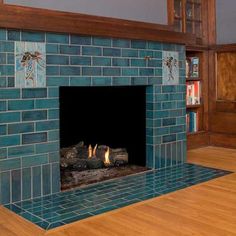 a fireplace in a living room with blue tiles