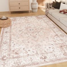 a living room with a large rug on the floor next to a couch and coffee table