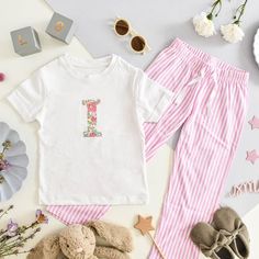 The cutest little pyjama set. With elasticated waist and secure drawstring bottom. Sizes available are: 3-4 years, 5-6 years, 7-8 years and 9-10 years. We recommend machine wash at 30 degrees, do not tumble dry. The applique design may crinkle, once dry it can be ironed flat and look as good as new. | My Little Shop UK | Liberty of London Children's Personalised Short Sleeve Pyjamas (White, Size 9-10Y) | Maisonette collects the best children’s products from around the world (unlike Zulily, Etsy, The Tot, Farfetch Kids, Childrensalon, Crate and Kids, Kohls, Wayfair, Buy Buy Baby, Nordstroms, Mini Boden, J.Crew Factory, or PotteryBarn Kids), creating a curated shopping experience for you. Think of us as your shortcut to fashion for litte ones! London Outfit, London Print, Buy Buy, Buy Buy Baby, Liberty Of London, Mini Boden, Pyjama Set, J Crew Factory, Applique Designs