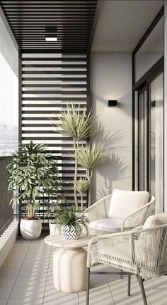 a balcony with white furniture and potted plants