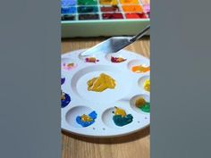 a paint palette and a knife on a table