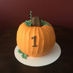 a pumpkin shaped cake sitting on top of a white plate