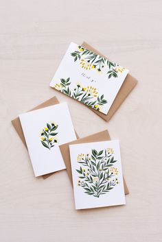 three cards with yellow and green flowers on them