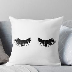 two black eyelashes on a white background throw pillow