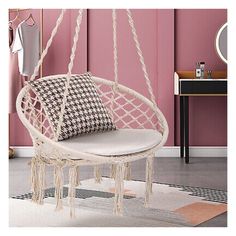 a white hanging chair in a pink room