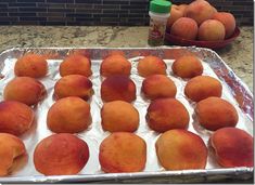 some peaches are sitting on top of tin foil and ready to be cooked in the oven