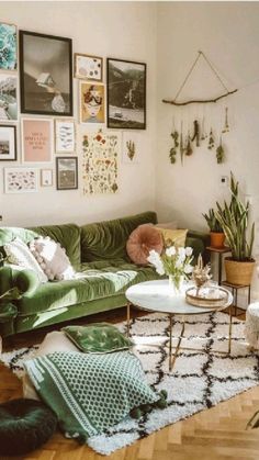 a living room filled with lots of furniture and pictures on the wall above it's coffee table