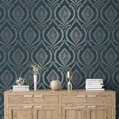 an ornate wallpaper design in grey and gold on a dark blue background with white accents