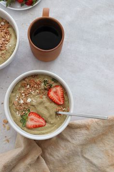 two bowls of oatmeal with strawberries and granola on the side