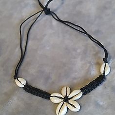 Handcrafted Cowrie Shell Flower Necklace Adjustable Necklace Ties In Back 9" Longest Length For Necklace, Can Adjust Down. Tags, Macrame, Crochet, Braided. Cowrie Shell Symbolizes Wealth & Fertility. Adjustable Flower Necklace For Beach, Adjustable Bohemian Flower Necklace, White Flower Jewelry For Vacation, Handmade Adjustable Flower Necklace For Beach, Handmade Black Flower Necklace, Adjustable White Flower Necklace, Black Necklaces For Vacation, Black Vacation Necklaces, Black Bohemian Flower Necklace