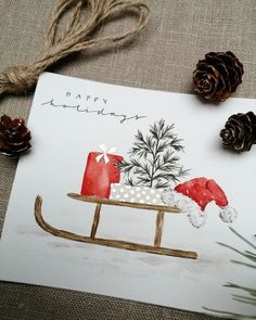 a christmas card with an image of a sleigh and pine cones on it