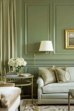 a living room with green walls and furniture