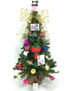 a small christmas tree decorated with buttons and bows