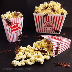 three red and white striped popcorn boxes with chocolate sprinkles