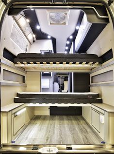 the interior of an rv with wood flooring and white walls, including black trim