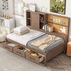 a bed with drawers underneath it in a room