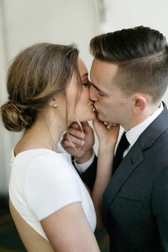 a man and woman are kissing each other