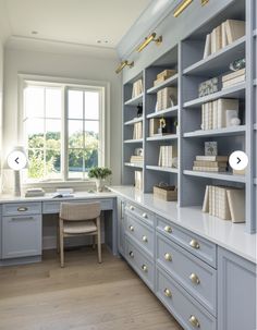 a home office with built in bookshelves and desk