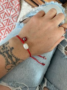 Simple cute yet powerful red string bracelet with a red flat evil eye charm and a pearl bead. A bracelet that will keep you safe and stylish at the same time. Wear it by itself or match it with other accessories, its perfect for layering also. These are size adjustable what makes them the perfect friendship matching gifts. A most have addition to your bracelet collection. ⚡️GET 20% OFF NOW⚡️ JOIN AKASHI'S VIP LIST and Shop ⚡️Join Akashi's VIP list for early bird discount access⚡️ Paste into your Adjustable Red Jewelry With Pearl Charm, Handmade Adjustable Red Pearl Bracelet, Handmade Red Adjustable Pearl Bracelet, Adjustable Red Pearl Bracelet As A Gift, Adjustable Red Pearl Bracelet Gift, Adjustable Casual Pearl Charm Jewelry, Casual Adjustable Pearl Charm Jewelry, Red Thread Bracelet, Nazar Bracelet