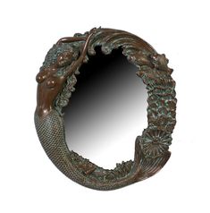 a mirror that is shaped like a mermaid