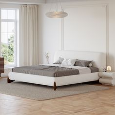 a white bed sitting on top of a hard wood floor next to a dresser and window