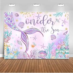 a mermaid themed wall mural with the words under the sea