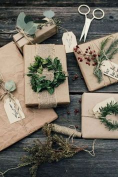 several wrapped presents are sitting on a table with scissors and twine tied to them