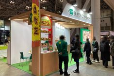 a group of people standing in front of a booth