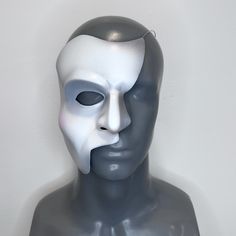 Inspired by the Toronto production and the iconic style of musical theatre legend Colm Wilkinson, this mask exhibits more expressive features, with sharp angles and a slightly more dramatic paint scheme.  D E T A I L S : -- Lightweight & durable -- Airbrushed with water-based latex paint which resists peeling and cracking -- Painted using Maria Björnson's original shading instructions -- Thermoformed with high impact polystyrene plastic -- 18 gauge steel wire attached for easy wear (heavy-duty r Artistic Masks And Prosthetics For Theater Halloween, Artistic Masks For Theater And Halloween, Artistic Halloween Masks For Theater, Artistic Halloween Theater Masks, Artistic White Mask For Theater, Artistic White Masks And Prosthetics For Theater, Artistic Theater Eye Mask, Artistic Eye Mask For Theater, Artistic Masks For Art Events