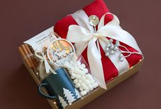 a gift box with coffee, marshmallows, cinnamon sticks and other items