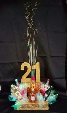 a table topped with lots of bottles and confetti next to a number sign