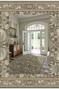 an ornate rug is in the middle of a room that has french doors and windows