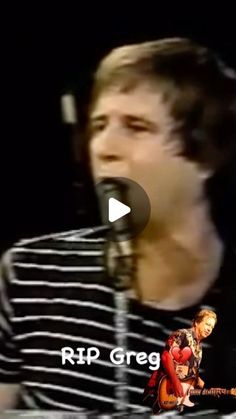 a young man singing into a microphone with the words rip greg on his face