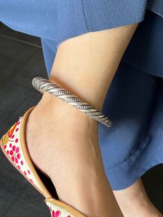 RESTOCKED ♥️ Elevate your ankle adornment with our premium Antique Ankle Kada, a testament to fine craftsmanship and timeless elegance. Meticulously handcrafted from pure 925 silver, this exquisite piece is a blend of heritage and contemporary sophistication. Its intricate design exudes charm and complements any style, from traditional to modern. Whether it's a special occasion or everyday wear, this Anklet Kada will add a touch of grace and refinement to your ensemble. Embrace the beauty of tradition and craftsmanship with this stunning piece that celebrates the artistry of silver. This is free size and is stretchable, can be worn easily. Weight: 43 grams for single piece. Inner Diameter: 8 cms Ceremonial Oxidized Bracelets, Festive Sterling Silver Anklets, Elegant Handmade Festive Anklets, Elegant Oxidized Anklets For Festivals, Elegant Adjustable Oxidized Anklets, Elegant Adjustable Anklets With Oxidized Finish, Elegant Adjustable Oxidized Finish Anklets, Elegant Handmade Sterling Silver Anklets, Oxidized Finish Anklets For Wedding