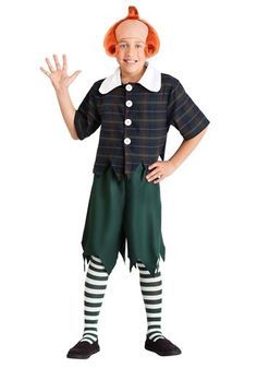 a little boy dressed in a costume with red hair and green pants, holding his hands out