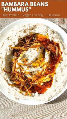 the hummus is served on a white plate