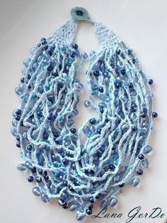 a crocheted necklace with blue beads