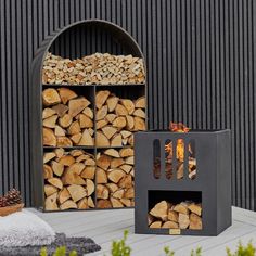 the firewood is stacked in front of an outdoor fireplace